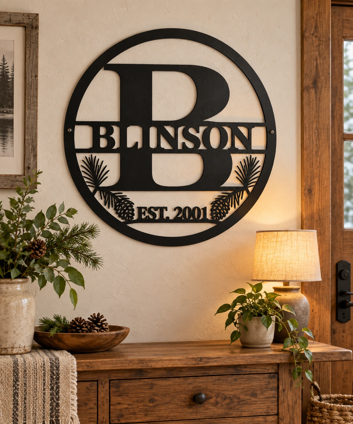 Blinson monogram metal family sign with pine accents in a warm entryway