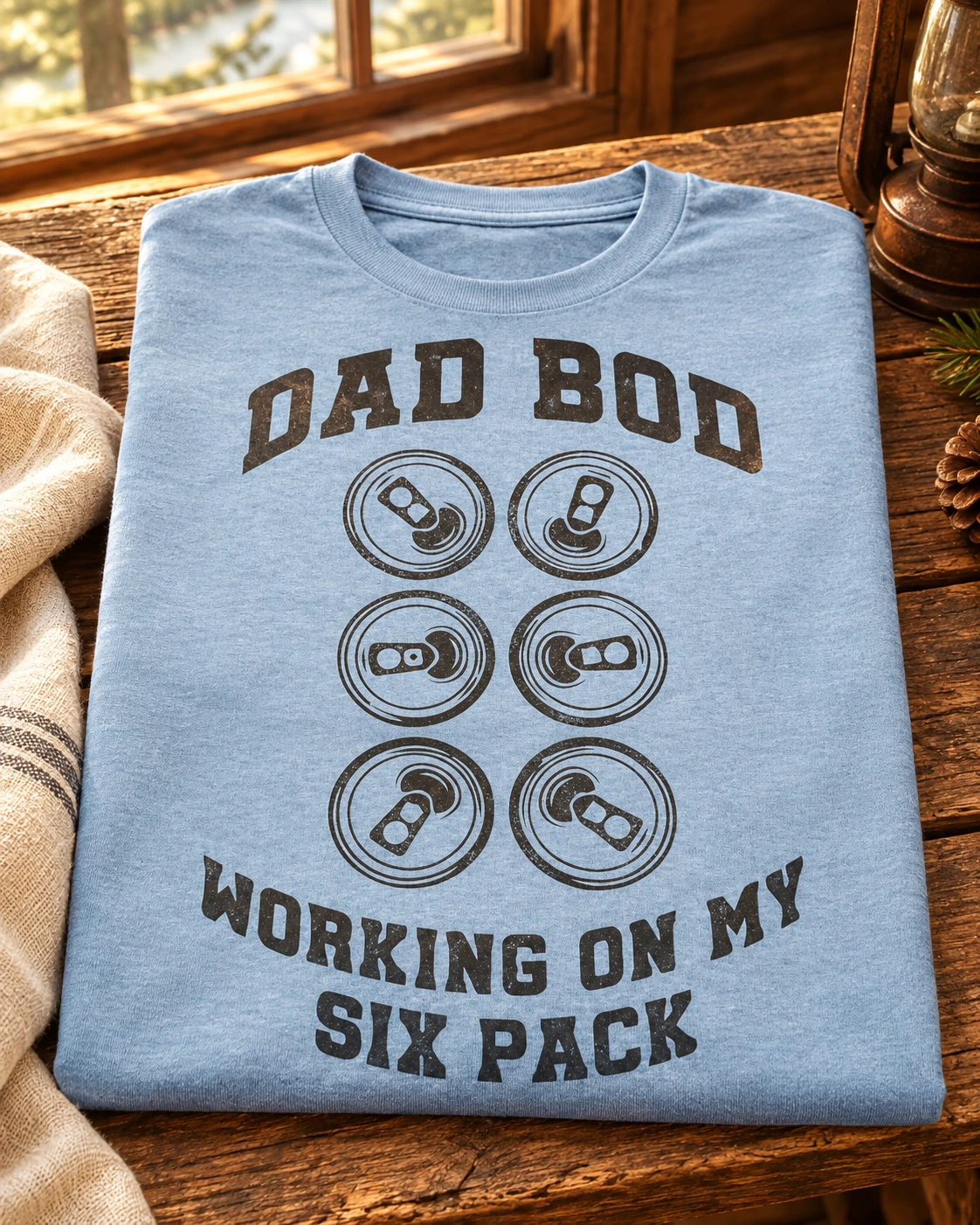 Dad Bod Hoodie or T-Shirt displayed in a warm styled setting