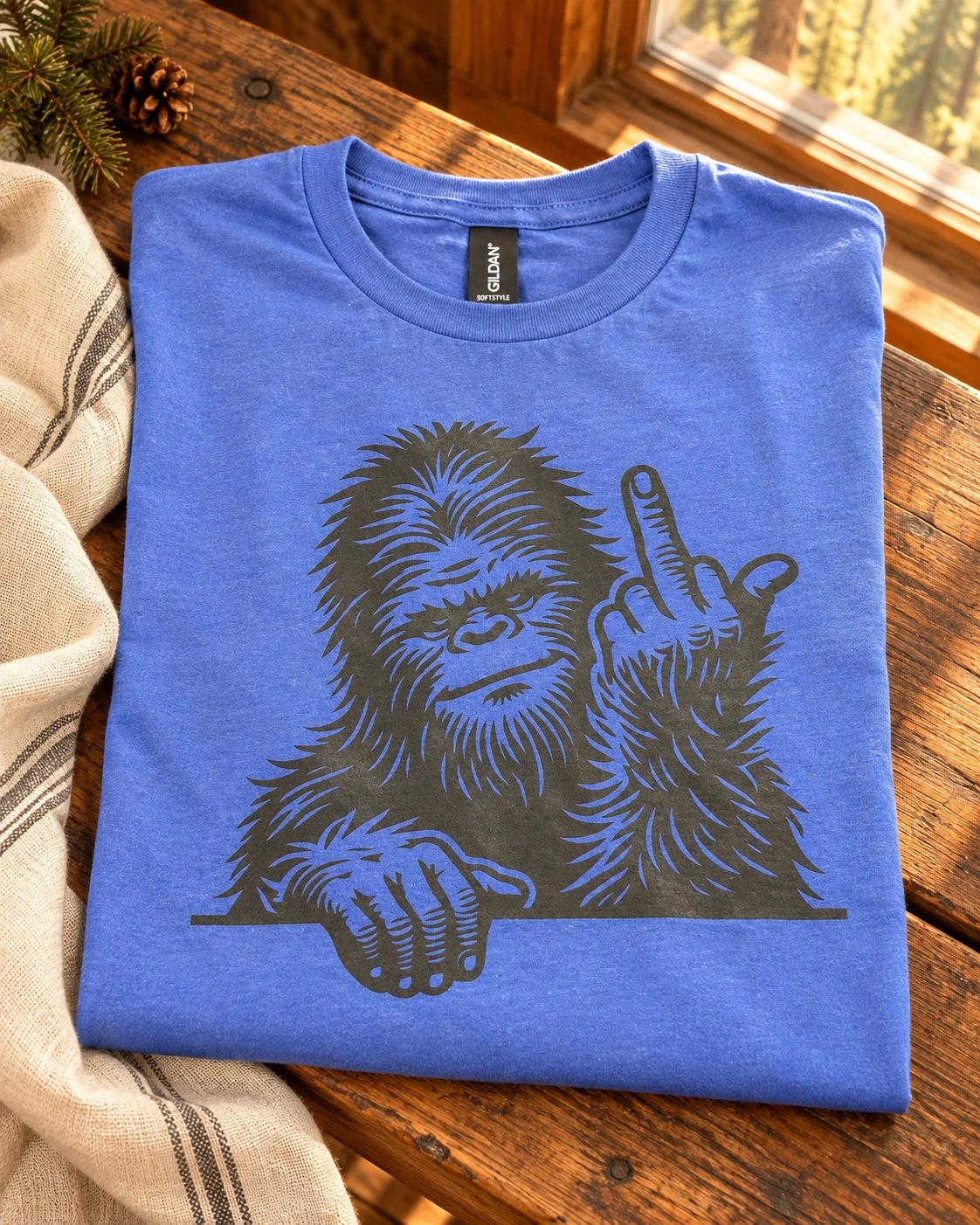 Sasquatch middle finger t-shirt displayed in a warm styled setting
